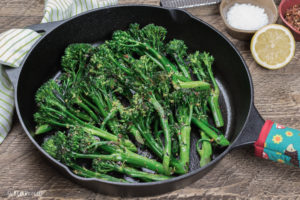 broccolini in a cast iron skillet with lemon