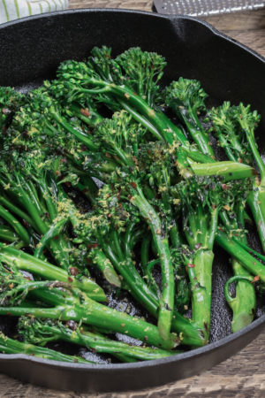 broccolini in a cast iron skillet with lemon