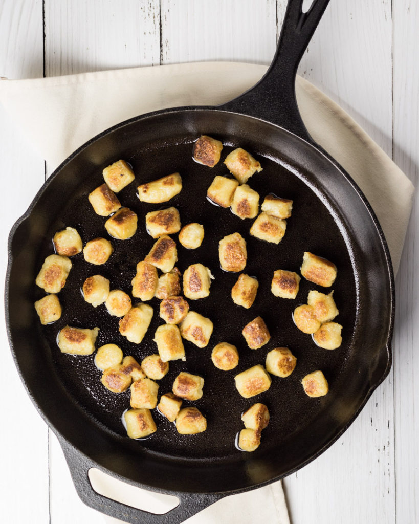 Glolden fried Cauliflower Gnocchi in a cast iron skillet