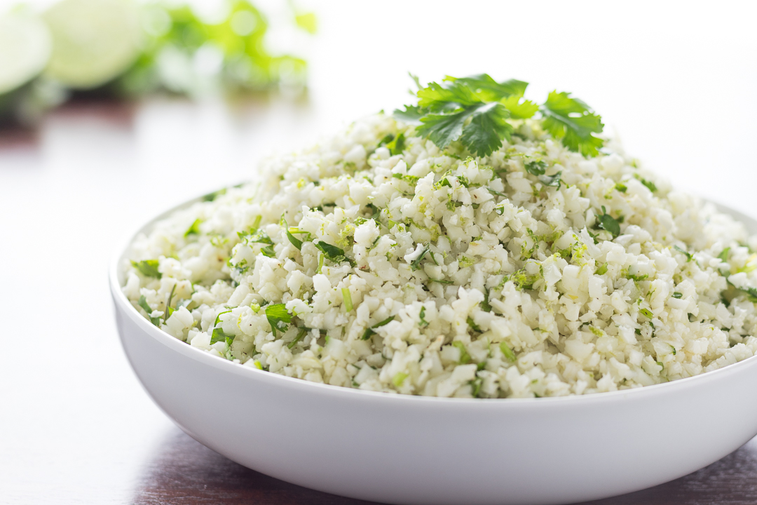 Cilantro Line Cauliflower Rice piled high in a white bowl