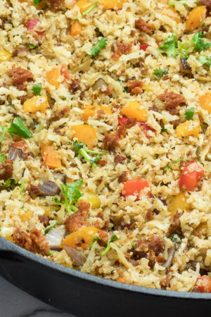 Chorizo Fried Cauliflower Rice with veggies in a cast iron skillet.