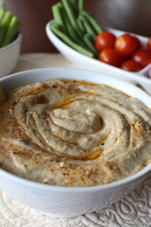 Baba Ganoush in a white bowl with veggies