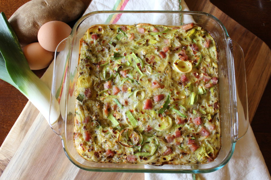 Potato, ham and leek ftitatta in a glass baking pan 