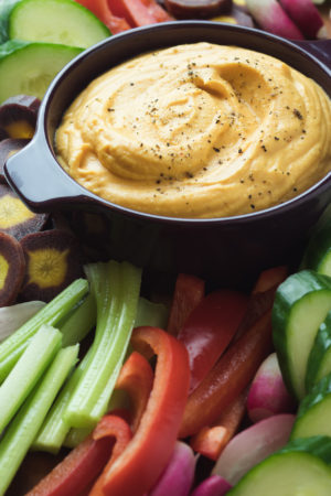 Sweet Potato Hummus surrounded by colorful veggies