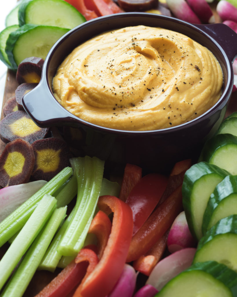 Sweet Potato Hummus surrounded by colorful veggies