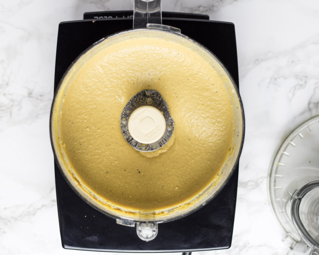 Creamy cashew Alfredo sauce in the food processor bowl from overhead.