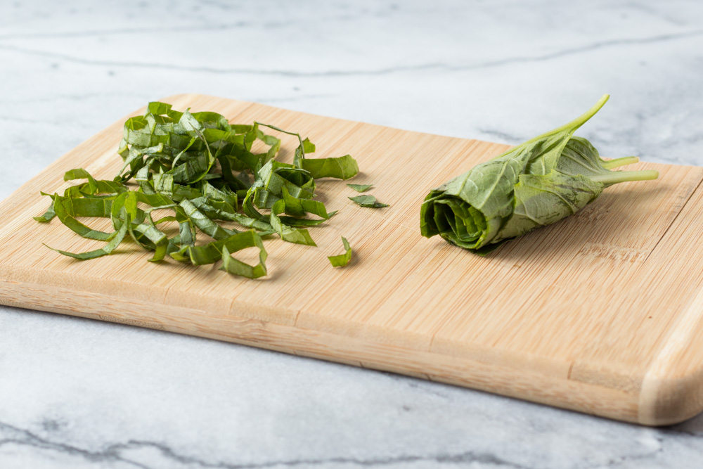 Basil rolled and sliced as a chiffonade.