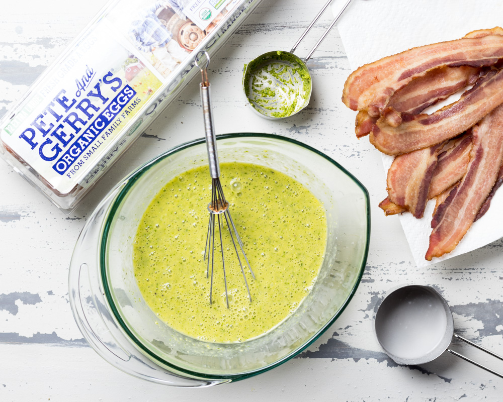 Pesto and coconut milk whisked into eggs accompanied by bacon