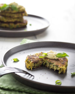 Zucchini and potato pancake on a plate with a bite taken out