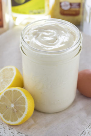 Homemade mayo in a canning jar joined by lemons an an egg