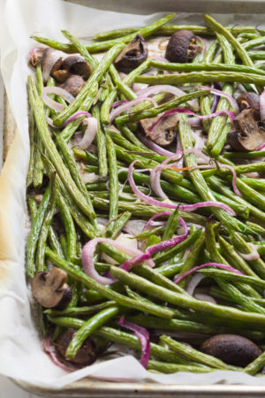Green beans mushrooms and onions baked on a sheet pan