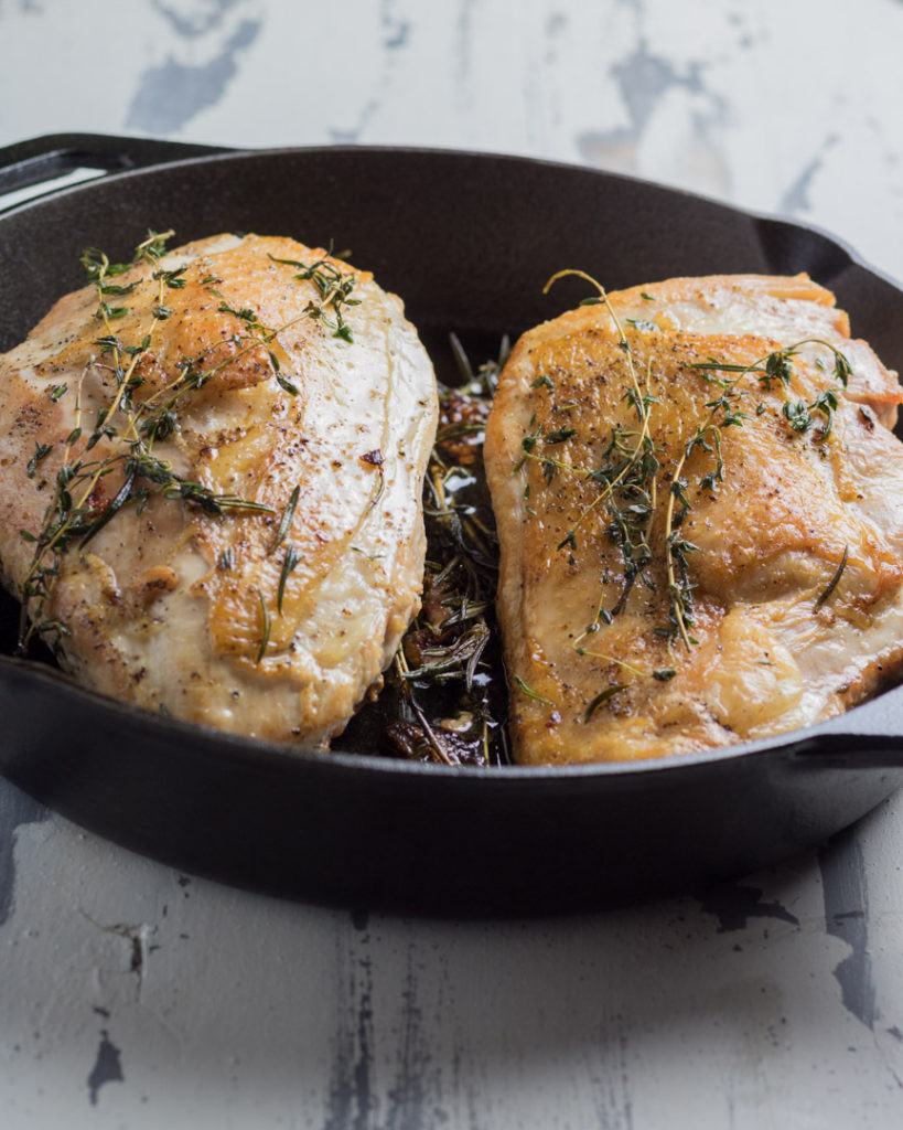 Herb roasted turkey breasts cooked in a cast iron pan