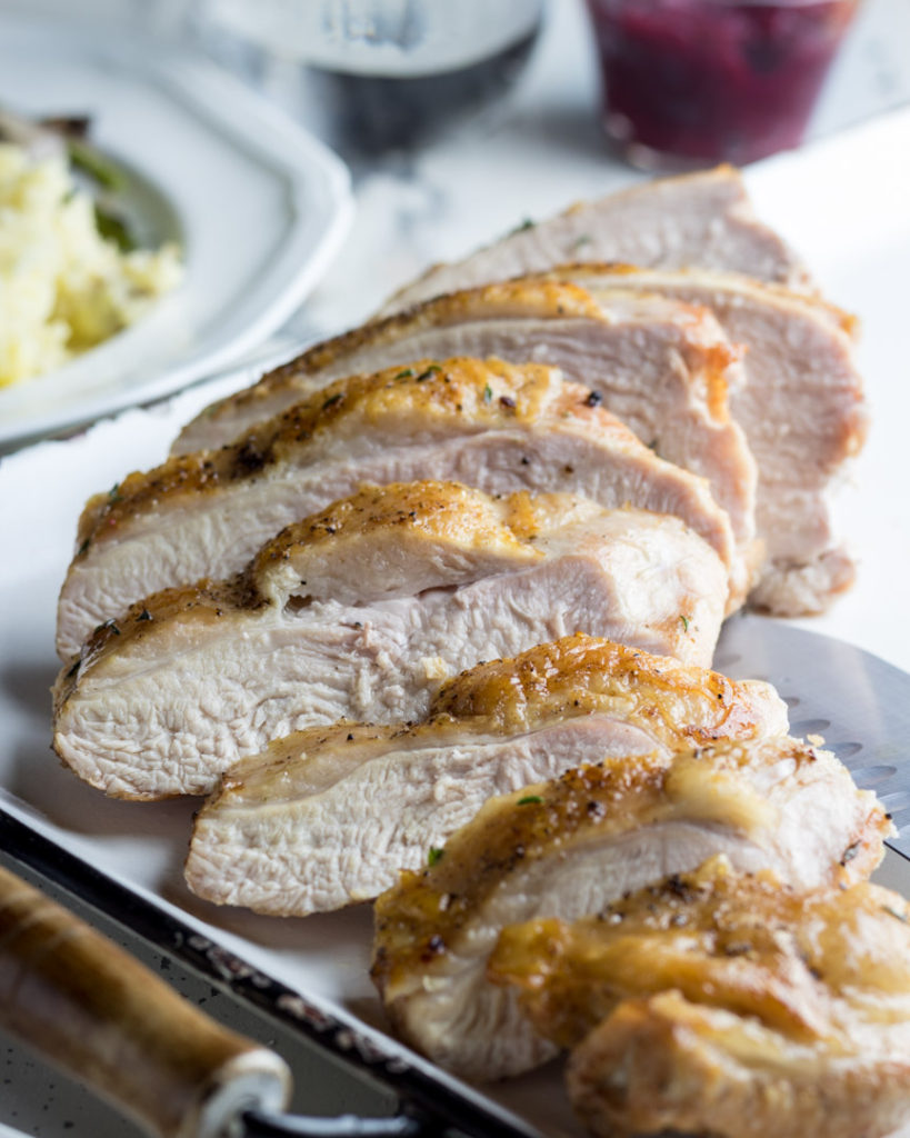 Sliced oven roasted turkey breasts on a platter