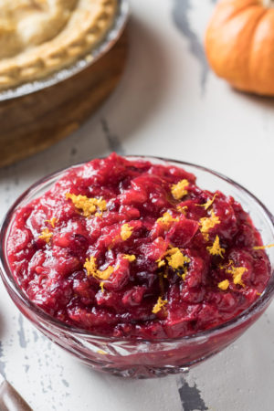 Instant pot cranberry sauce in a bowl topped with orange zest